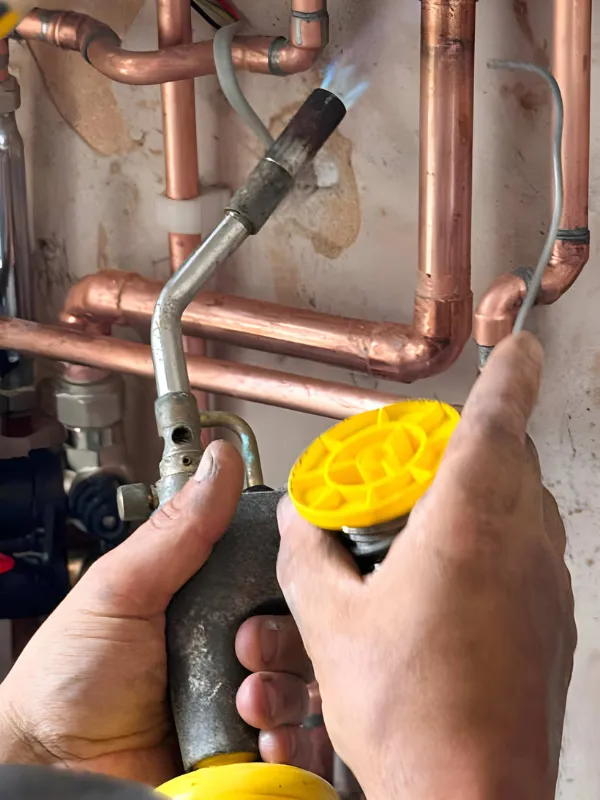 Plumber repairing pipe